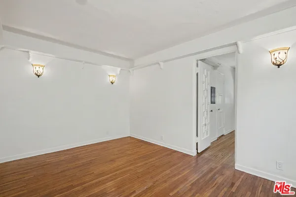 a view of a room with wooden floor