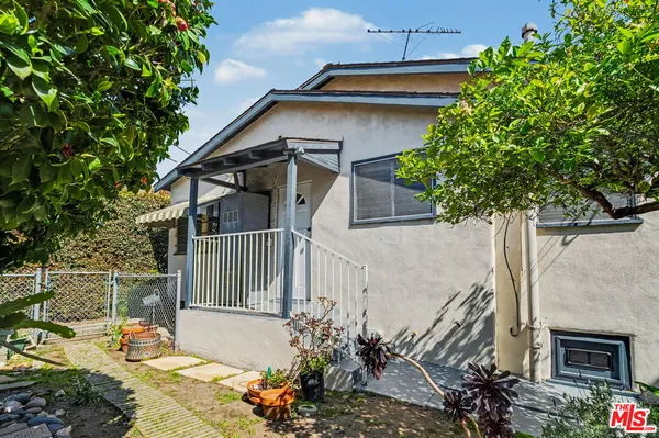 a house that has a tree in front of the house