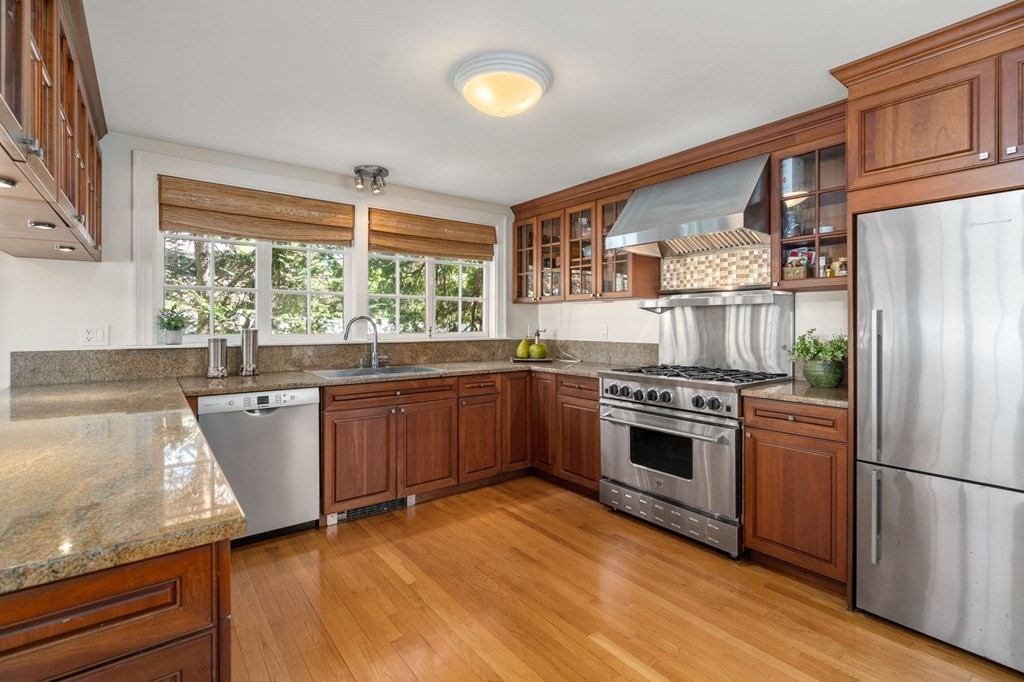 5 Hammond Street Newton, MA 02467 - Photo 21 of 40 a kitchen with stainless steel appliances granite countertop a stove a sink dishwasher and a refrigerator
