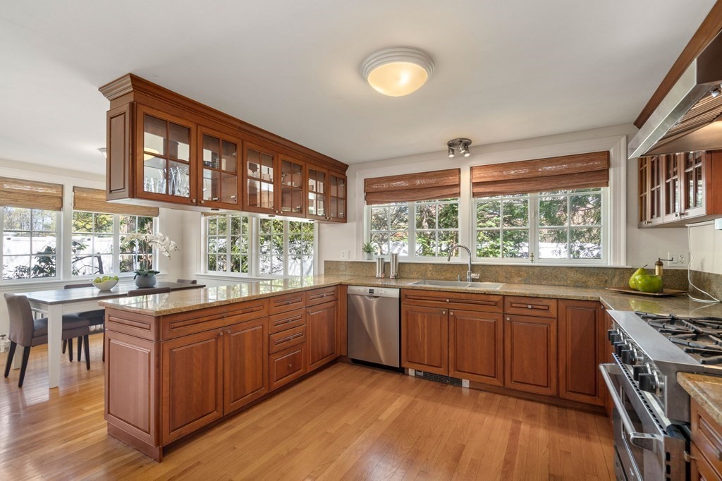 5 Hammond Street Newton, MA 02467 - Photo 22 of 40 a kitchen with stainless steel appliances granite countertop wooden cabinets a stove a sink and a large window