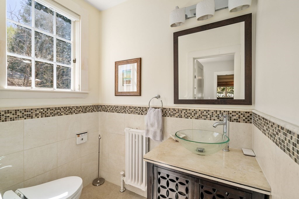 5 Hammond Street Newton, MA 02467 - Photo 25 of 40 a bathroom with a sink a toilet and shower