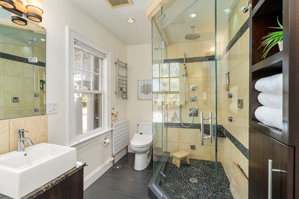 5 Hammond Street Newton, MA 02467 - Photo 31 of 40 a spacious bathroom with a double vanity sink toilet mirror and shower