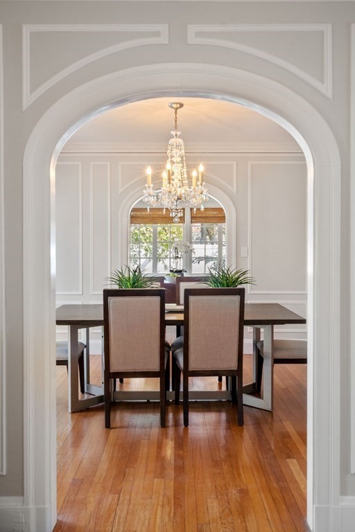 5 Hammond Street Newton, MA 02467 - Photo 8 of 40 a dining room with furniture a chandelier and wooden floor