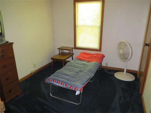 100 Green River Road Colrain, MA 01340 - Photo 14 of 17 a living room with a bed and a table