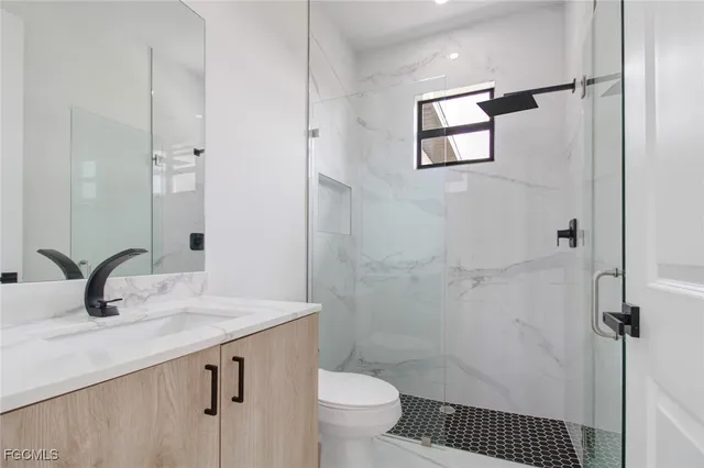 a bathroom with a sink toilet and shower