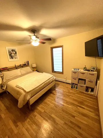 a bedroom with a bed and wooden floor