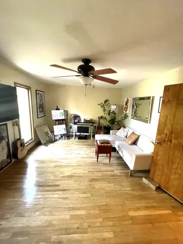 a view of a room with wooden floor and door