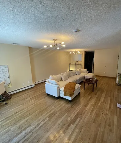 a living room with furniture and wooden floor