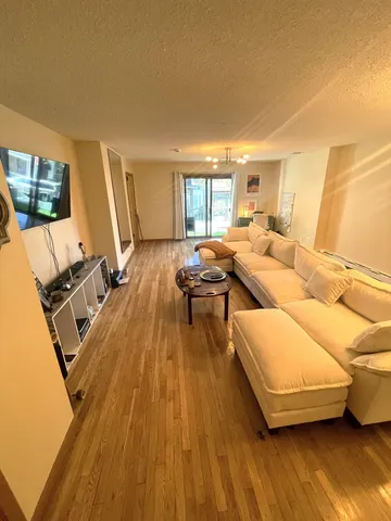 a living room with furniture and a wooden floor