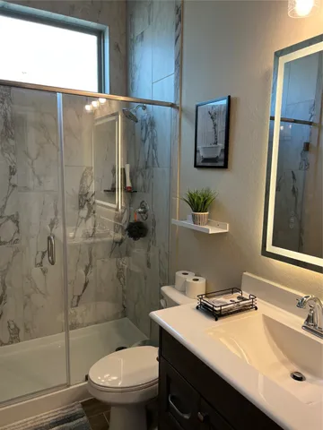 a bathroom with a sink toilet and shower