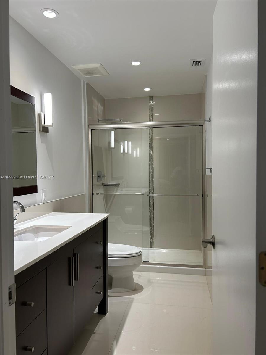 Kendale Lakes Miami, FL 33183 - Photo 8 of 12 a bathroom with a sink mirror toilet and bathtub