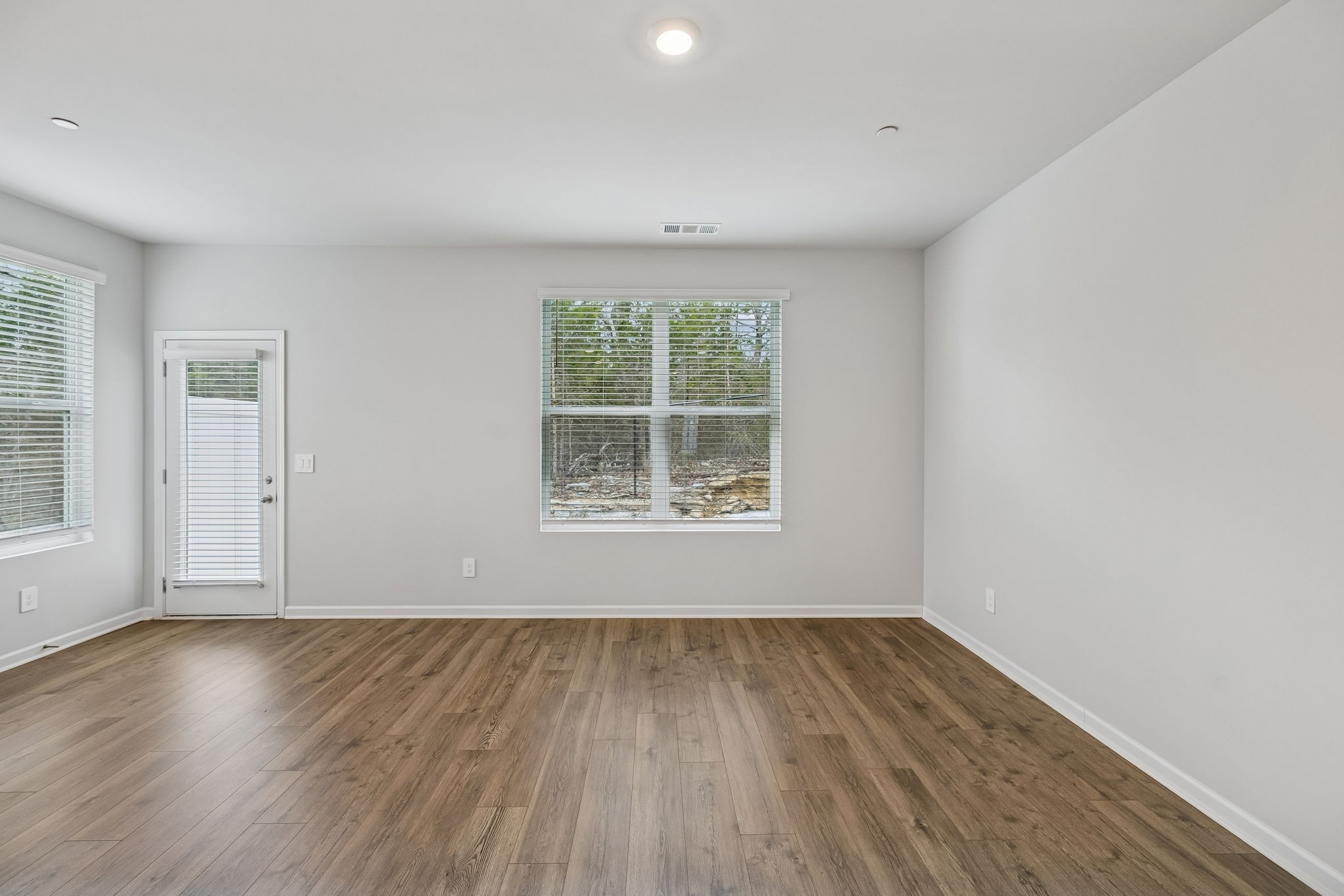 174 Mackenzie Way Lewisburg, TN 37091 - Photo 11 of 32 a view of an empty room with wooden floor and a window