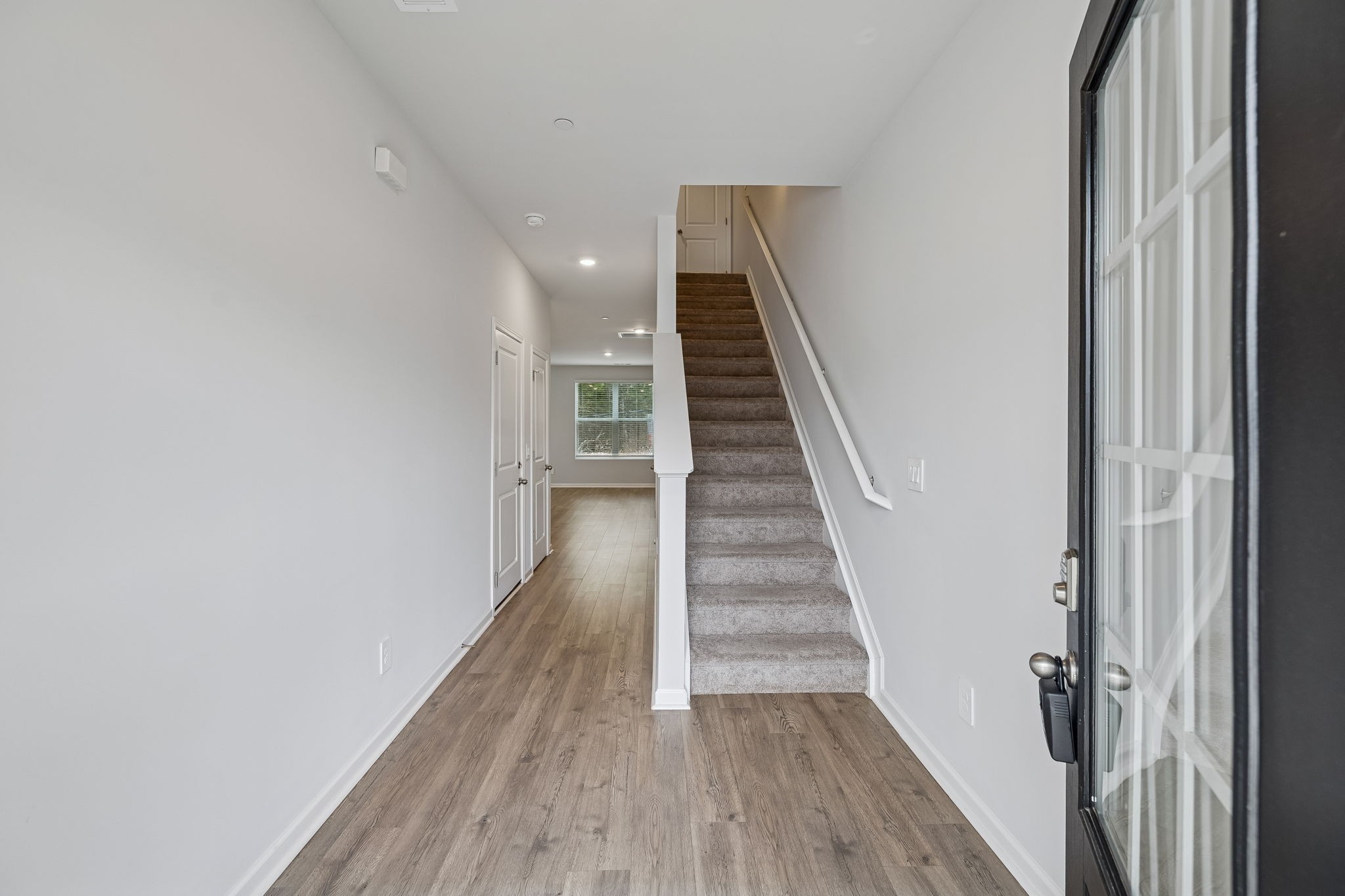 174 Mackenzie Way Lewisburg, TN 37091 - Photo 5 of 32 a view of a hallway with wooden floor and staircase