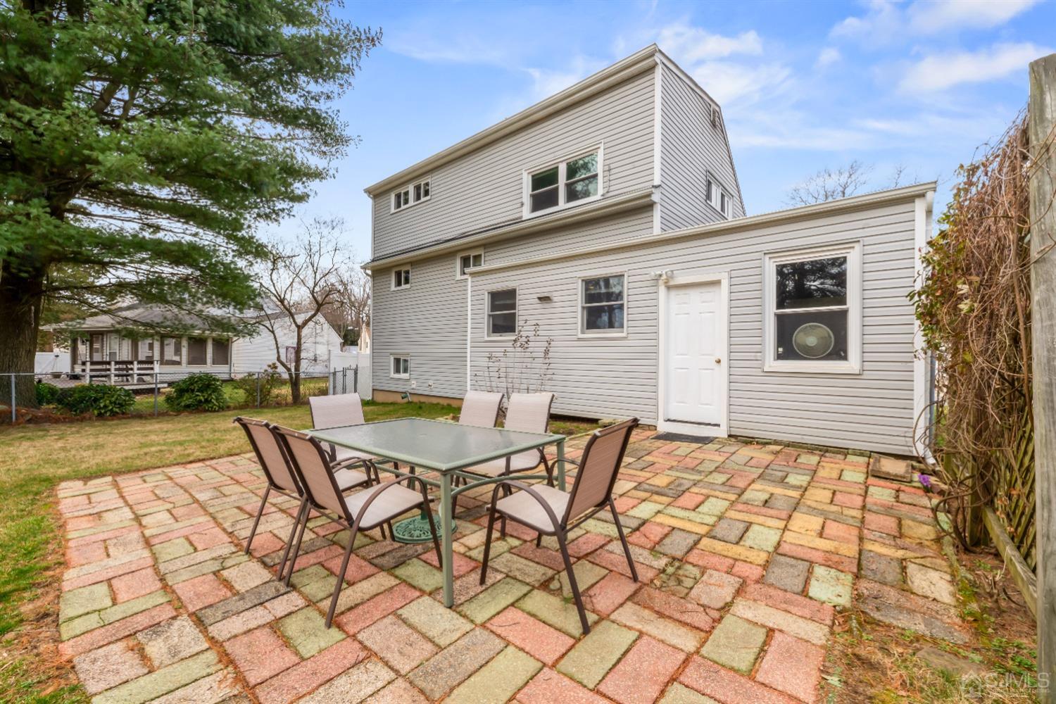 36 Shetland Road East Brunswick, NJ 08816 - Photo 15 of 22 a backyard of a house with barbeque oven table and chairs