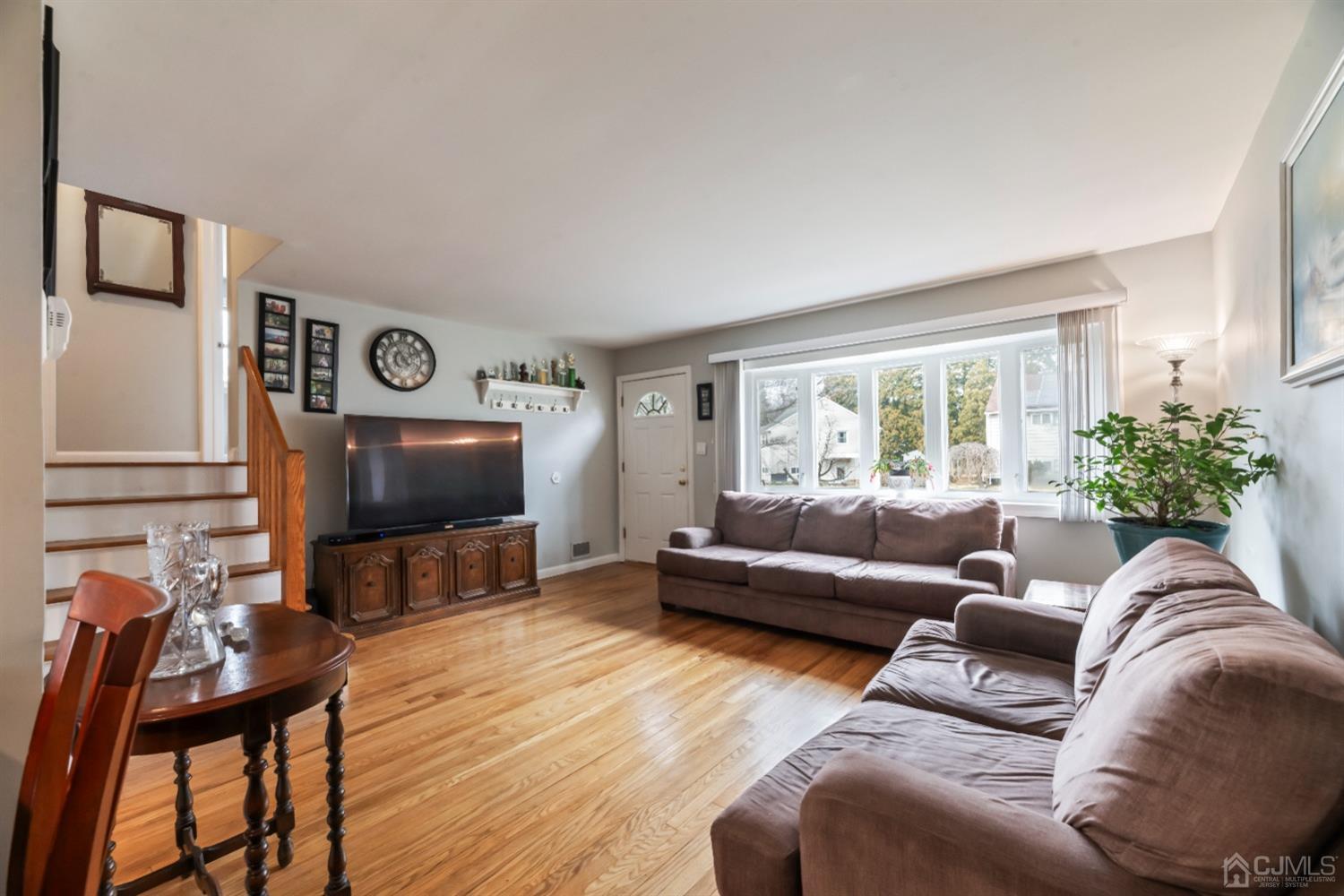 36 Shetland Road East Brunswick, NJ 08816 - Photo 3 of 22 a living room with furniture a flat screen tv a rug and a window