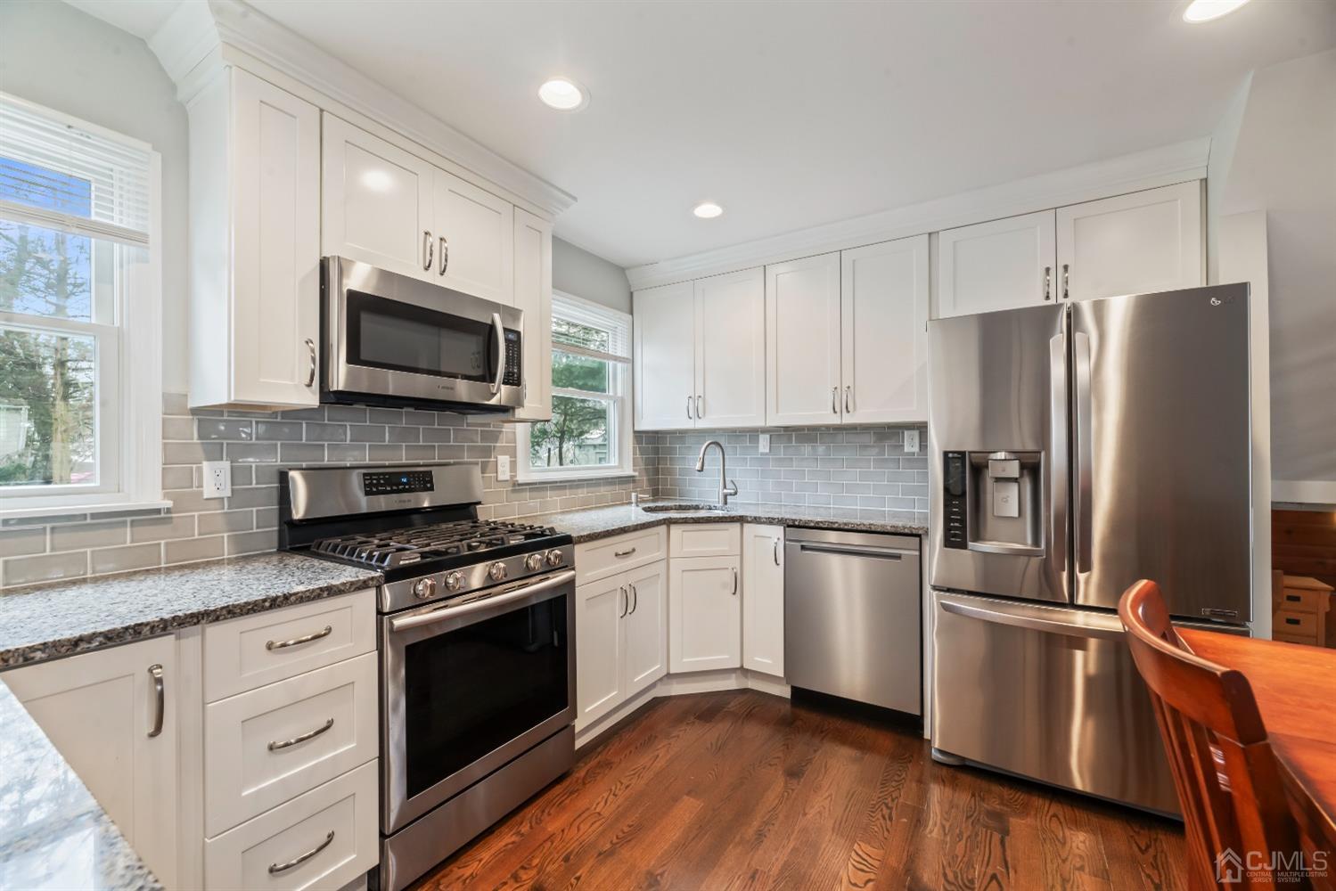 36 Shetland Road East Brunswick, NJ 08816 - Photo 5 of 22 a kitchen with granite countertop a refrigerator stove and microwave
