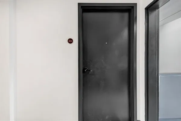 a view of front door with wooden floor