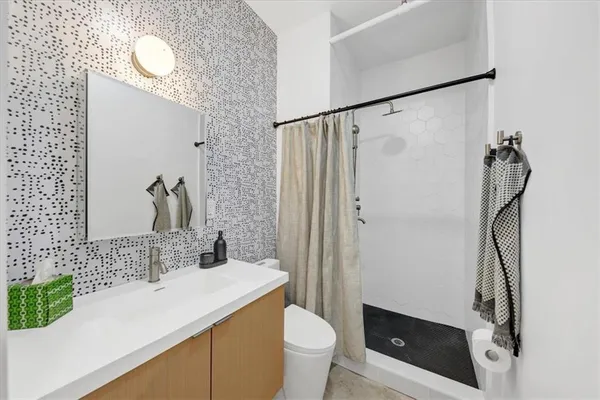 a bathroom with a sink toilet and shower