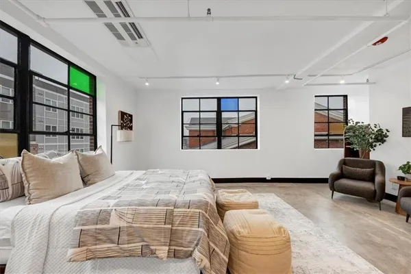 a bedroom with a bed and a couch