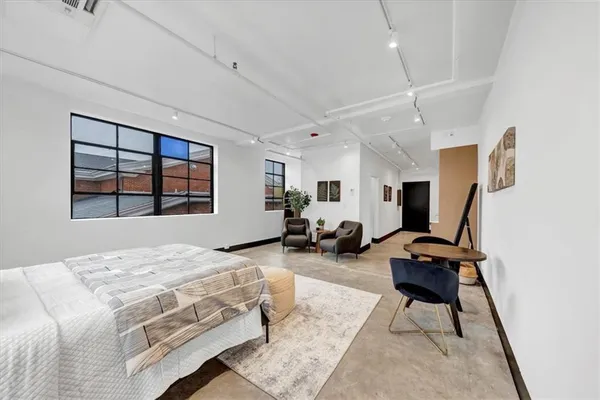 a bedroom with bed and window