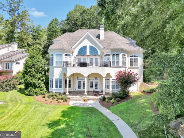 a front view of a house with yard and green space