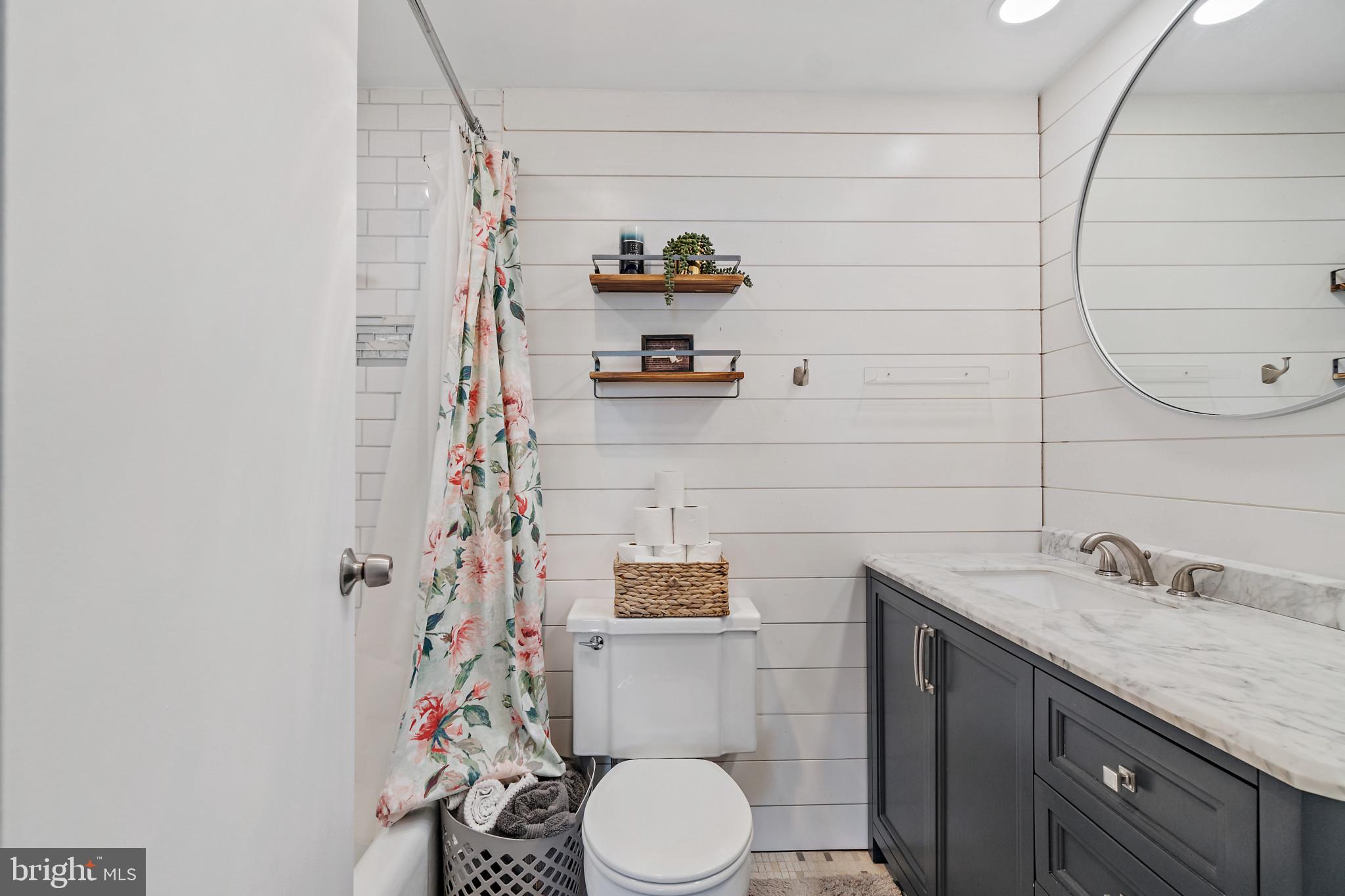 4401 Roland Avenue, Unit 507 Baltimore, MD 21210 - Photo 13 of 26 Shiplap wall detail in primary ensuite bath