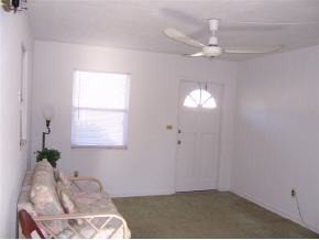 1042 Northeast Cable Palm Bay, FL 32905 - Photo 6 of 6 a room with a bed and a chandelier