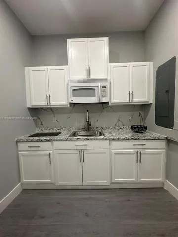 a kitchen with a stove a refrigerator and a sink