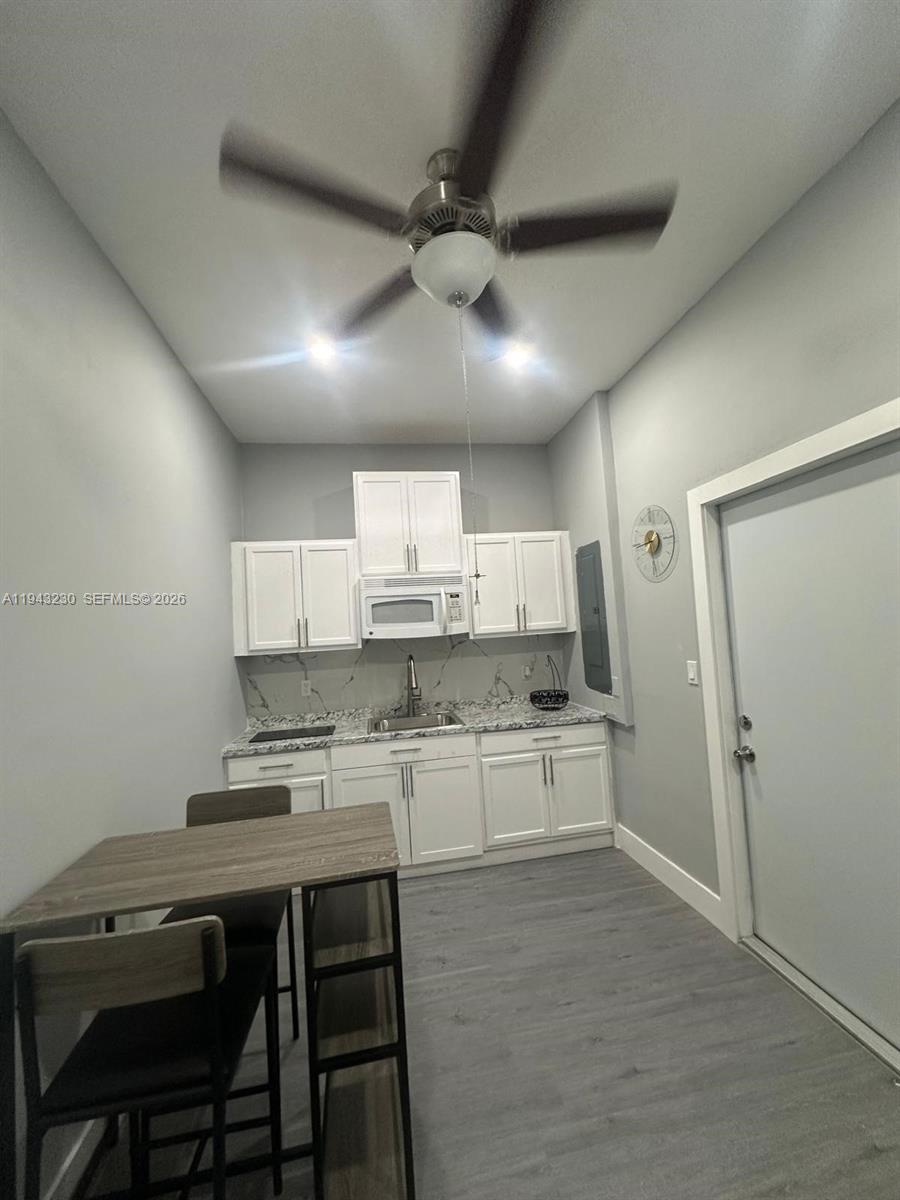 11879 Southwest 253rd Terrace Homestead, FL 33032 - Photo 12 of 15 a kitchen with a stove a refrigerator and a sink