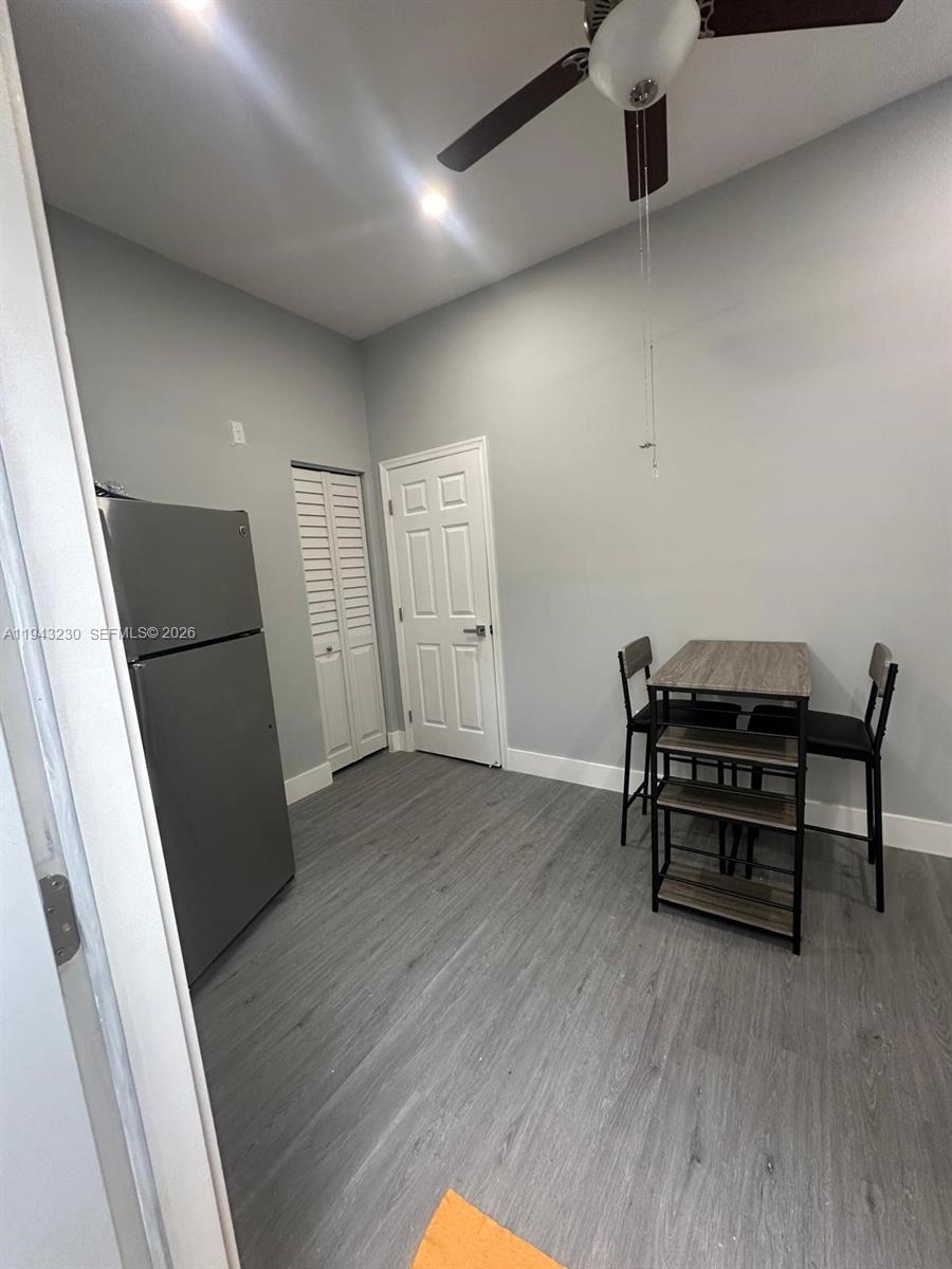 11879 Southwest 253rd Terrace Homestead, FL 33032 - Photo 14 of 15 wooden floor and chair in a room