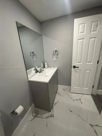 a bathroom with a sink a mirror and a toilet