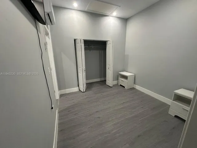 a view of a room with wooden floor and a sink