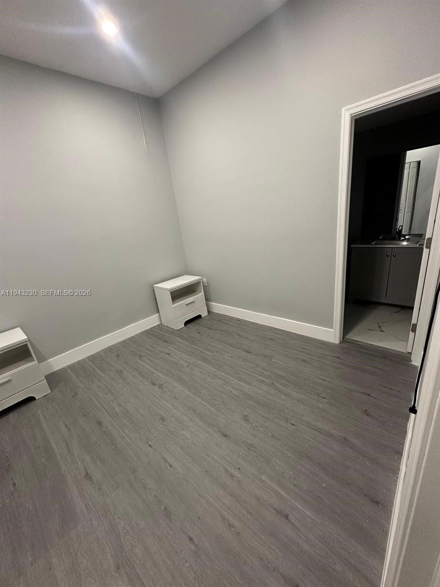 11879 Southwest 253rd Terrace Homestead, FL 33032 - Photo 8 of 15 a view of a room with wooden floor and a sink