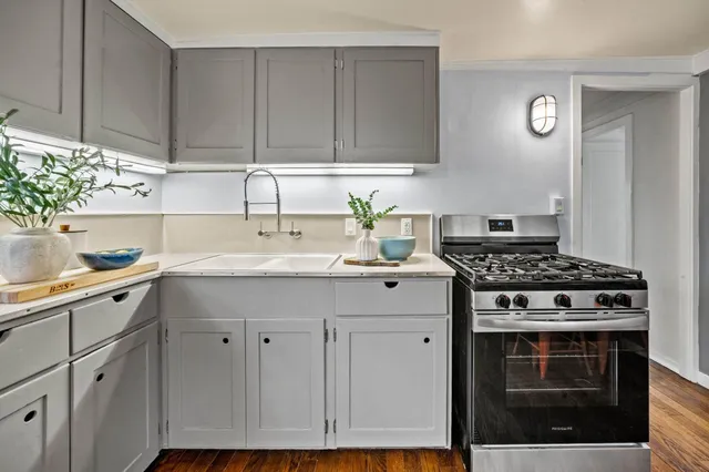 a kitchen with cabinets appliances and a sink