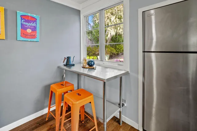 a view of a room that has a table and a window