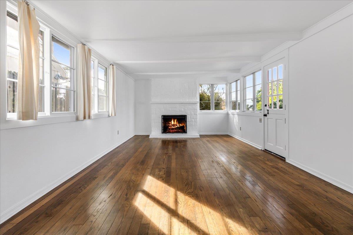 24747 Valley Way Carmel, CA 93923 - Photo 2 of 24 a view of empty room with wooden floor and fireplace