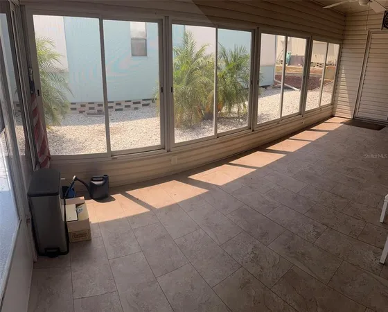 a view of an empty room and a window