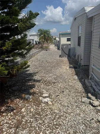 a backyard of a house with table and chairs