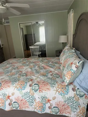 a bedroom with a bed and a mirror