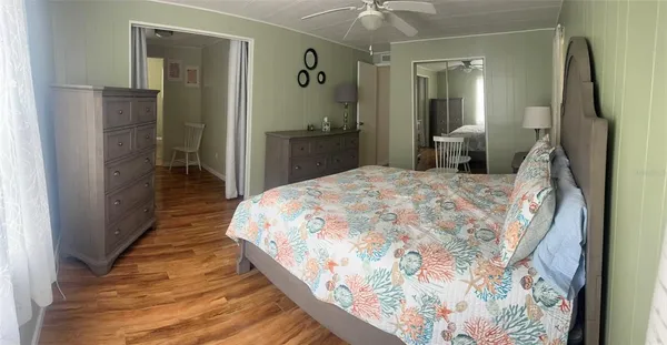 a bedroom with a bed and a mirror