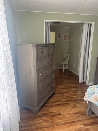 a room with wooden floors and furniture