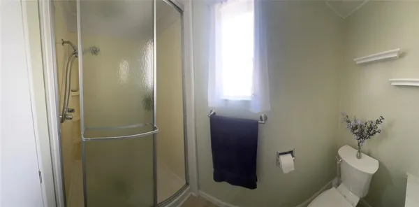 a bathroom with a toilet and a shower