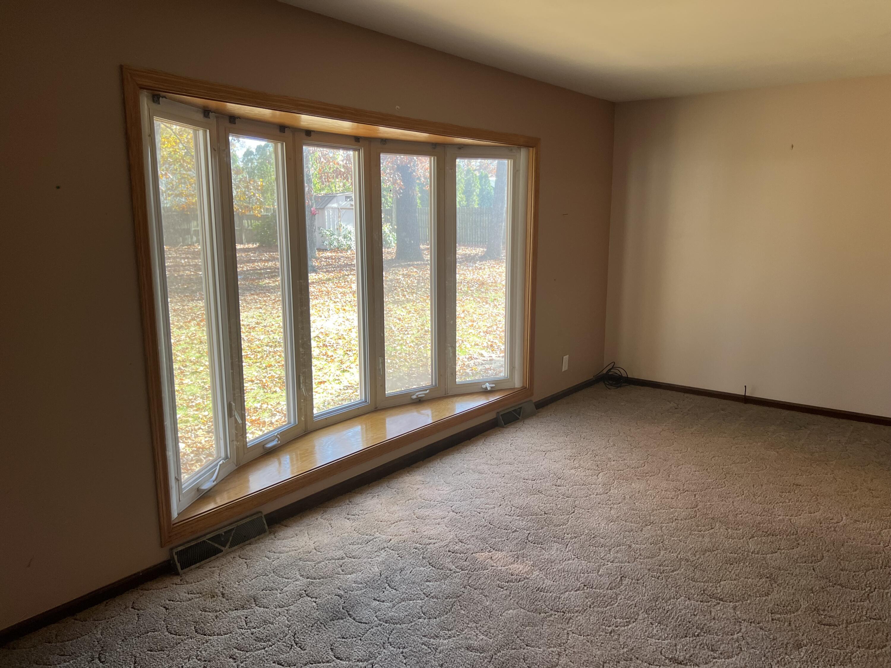 12243 Duttlinger Lane Wheatfield, IN 46392 - Photo 12 of 27 a view of an empty room with a large window