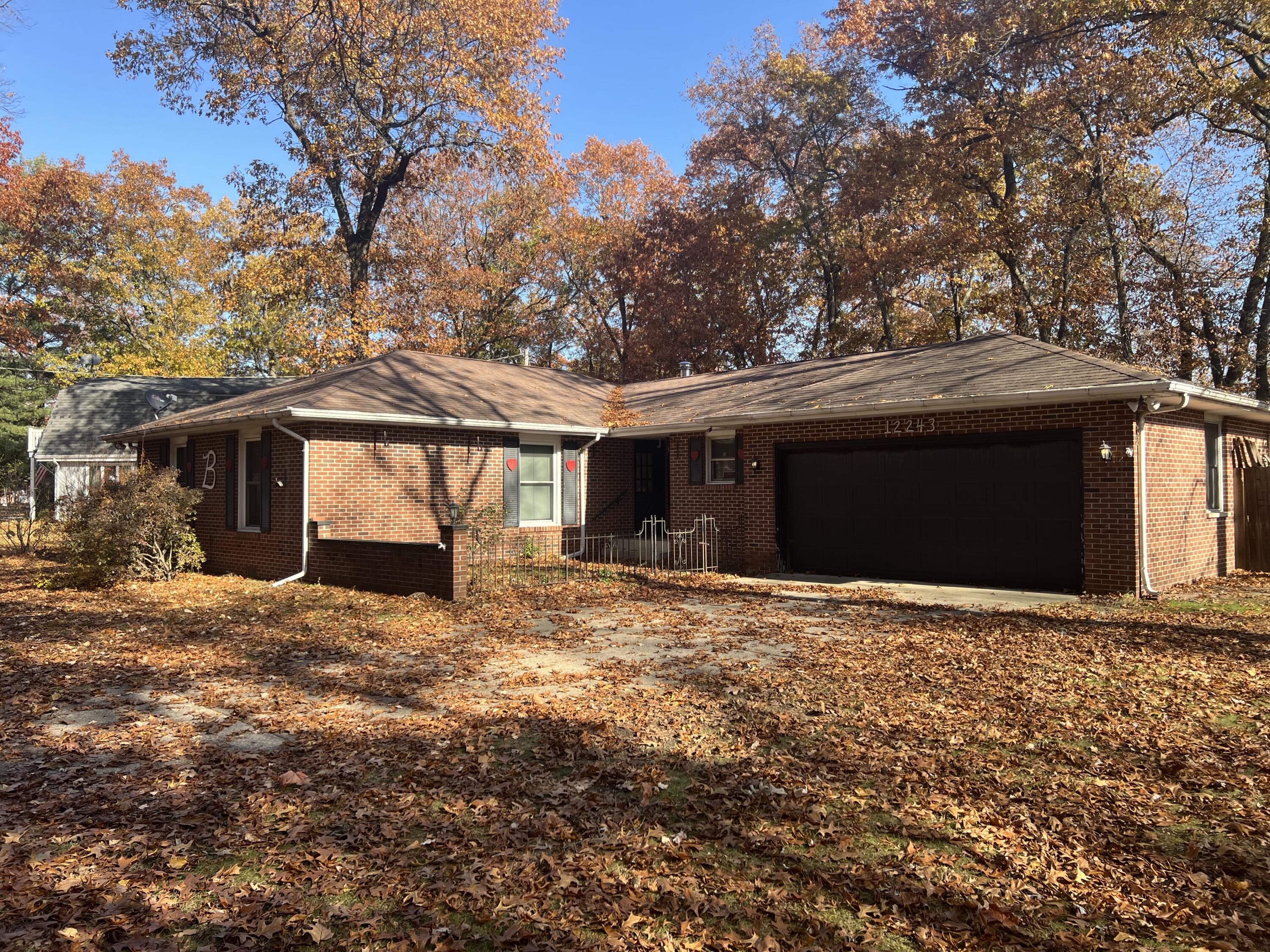 12243 Duttlinger Lane Wheatfield, IN 46392 - Photo 2 of 27 a front view of a house with a yard