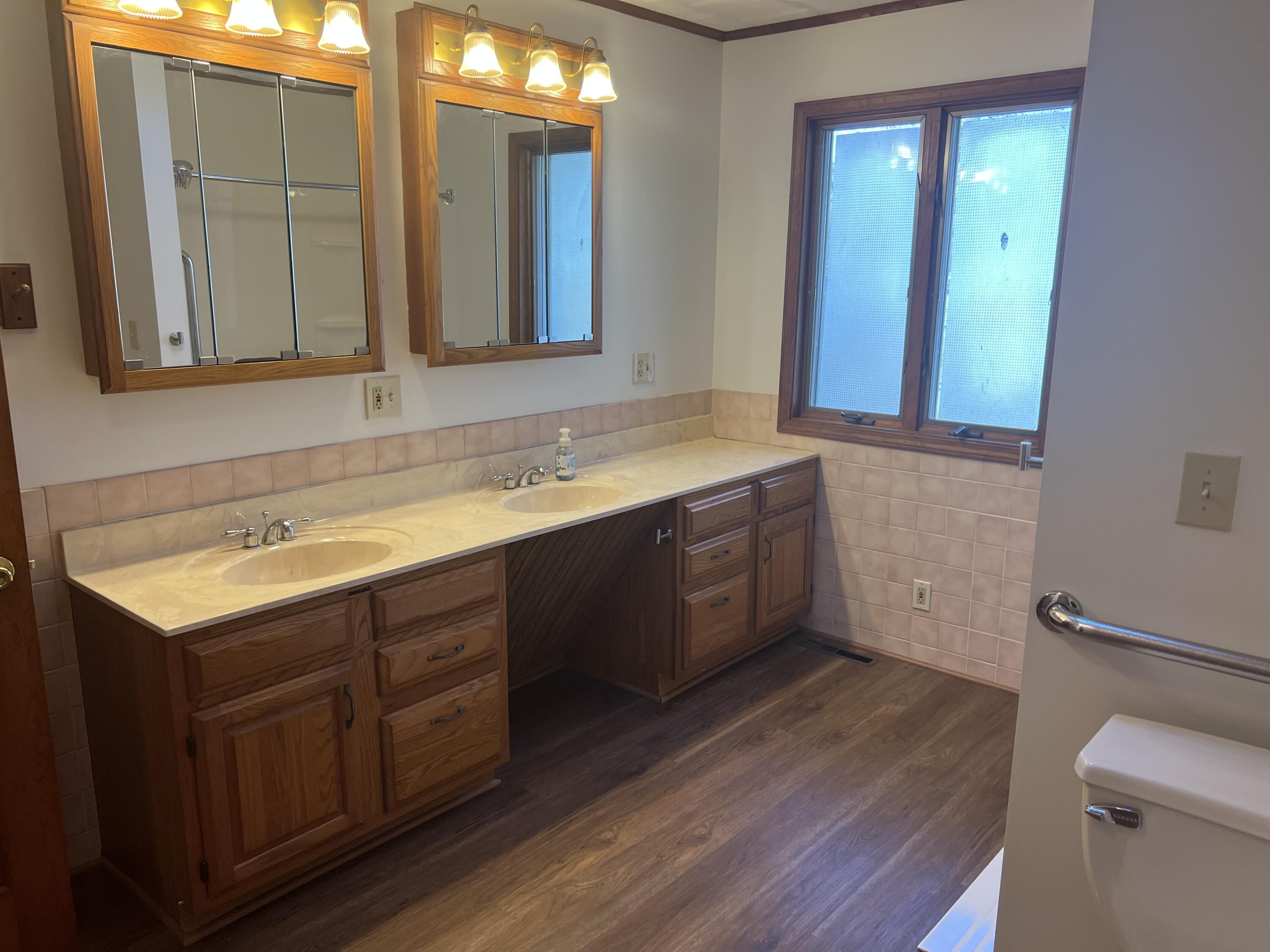 12243 Duttlinger Lane Wheatfield, IN 46392 - Photo 23 of 27 a bathroom with a sink and a mirror