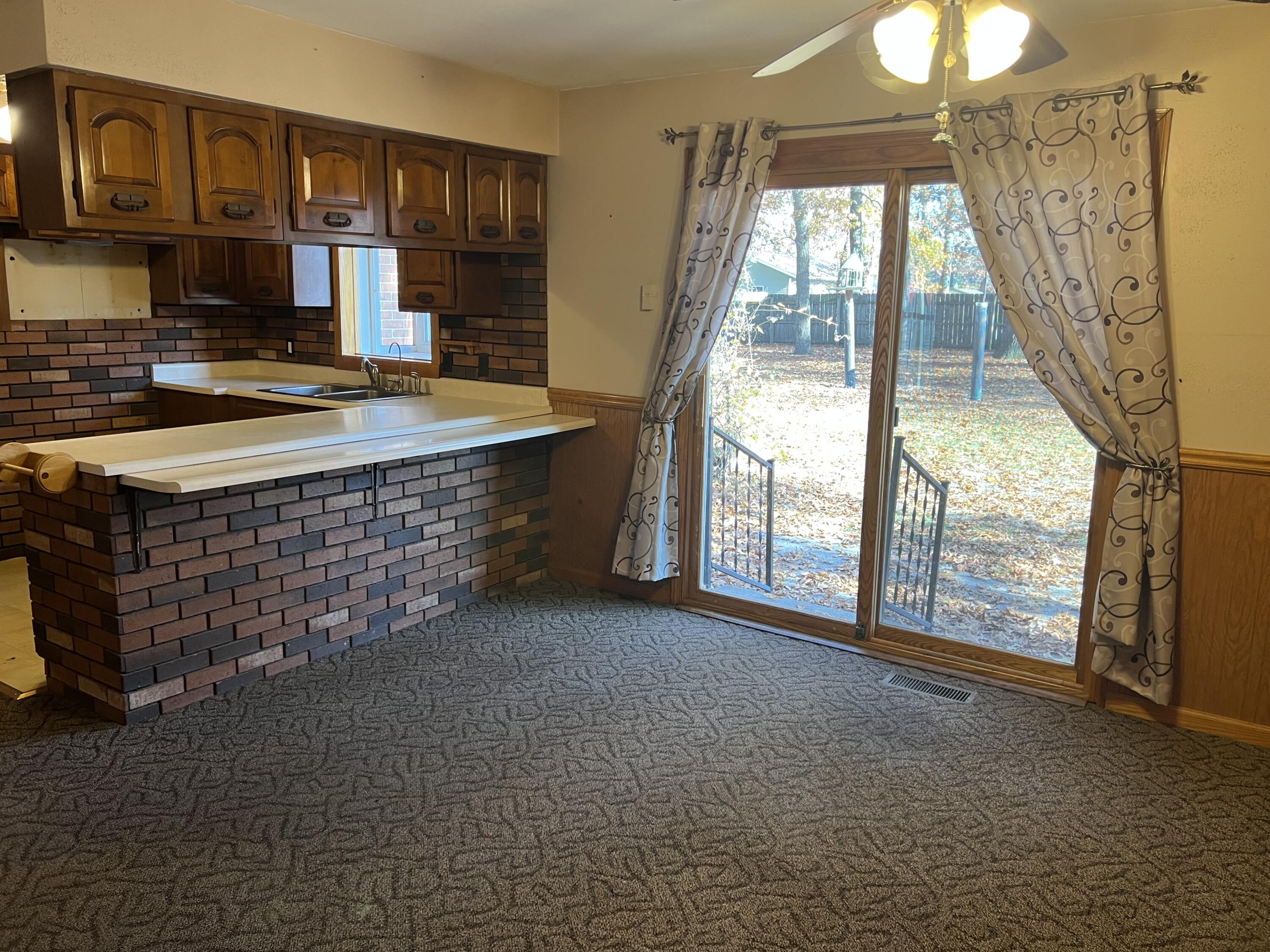 12243 Duttlinger Lane Wheatfield, IN 46392 - Photo 6 of 27 a view of an empty room with window and chandelier fan