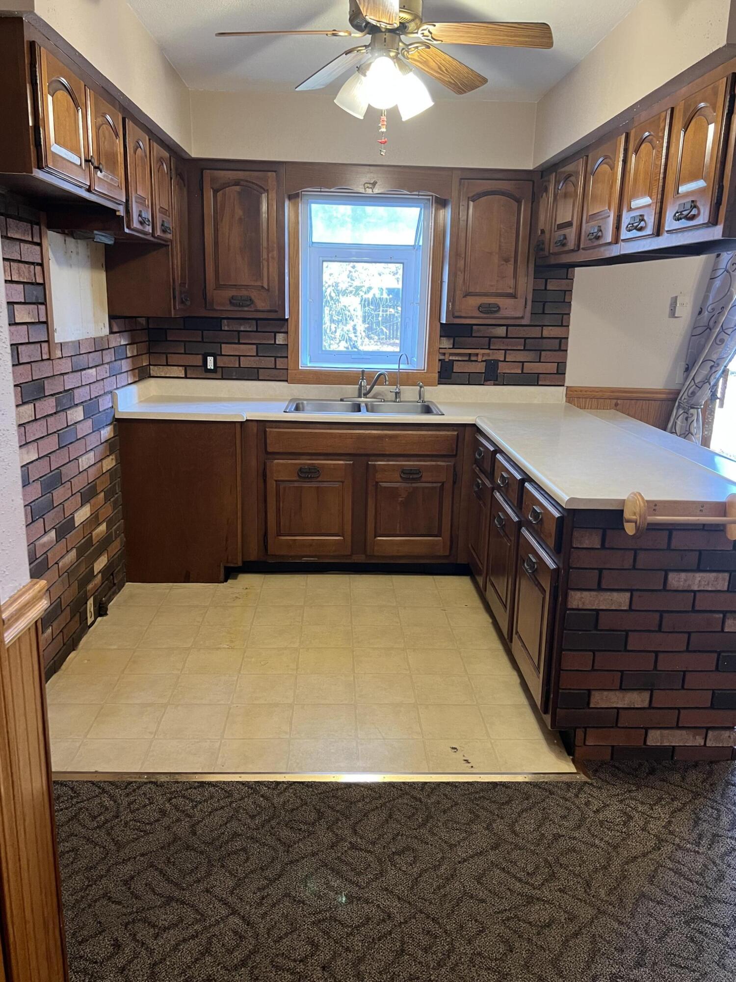 12243 Duttlinger Lane Wheatfield, IN 46392 - Photo 7 of 27 a kitchen with stainless steel appliances granite countertop a stove a sink dishwasher and a refrigerator