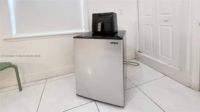 a kitchen with a refrigerator and a stove