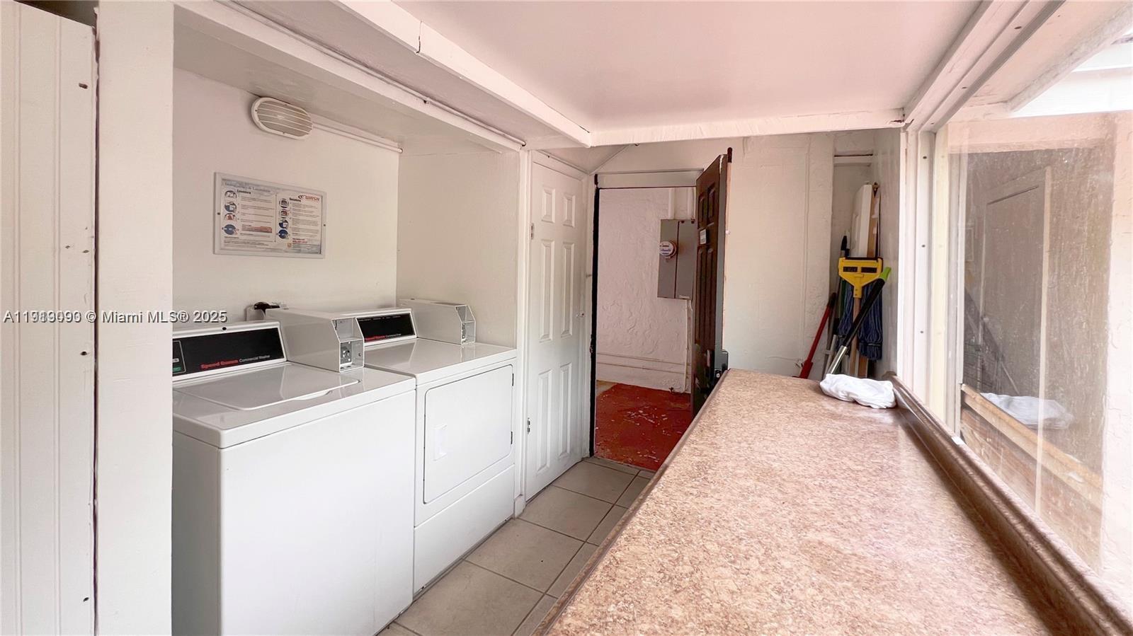 1950 Southwest 5th Street, Unit 2 Miami, FL 33135 - Photo 7 of 11 a view of a hallway with washer and dryer