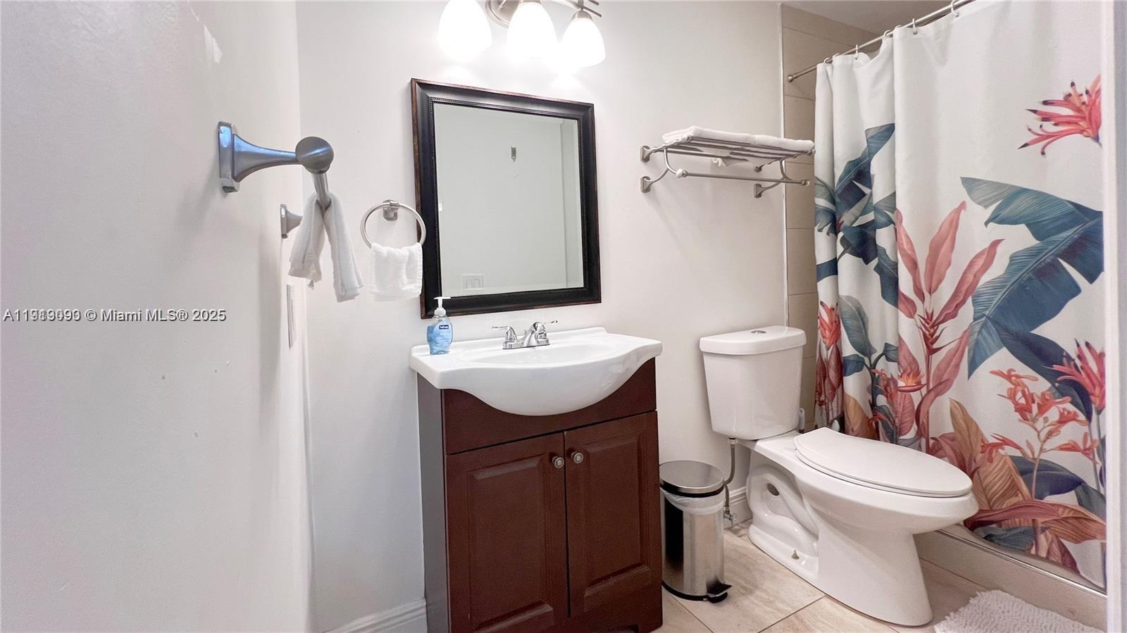 1950 Southwest 5th Street, Unit 2 Miami, FL 33135 - Photo 8 of 11 a bathroom with a toilet sink and mirror